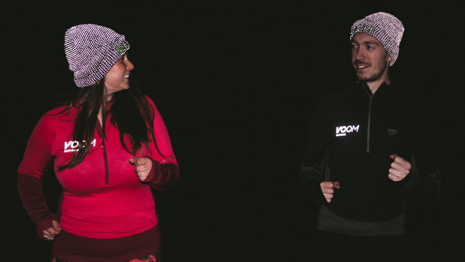 Two runners wearing reflective running hats