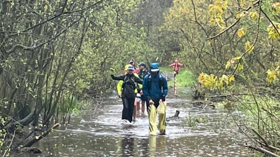 Runners wading through deep water at the Dukeries 30 and 40