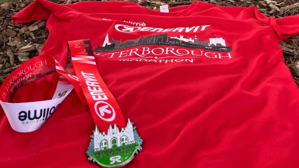 Medal and technical t-shirt for the 2021 Peterborough Marathon