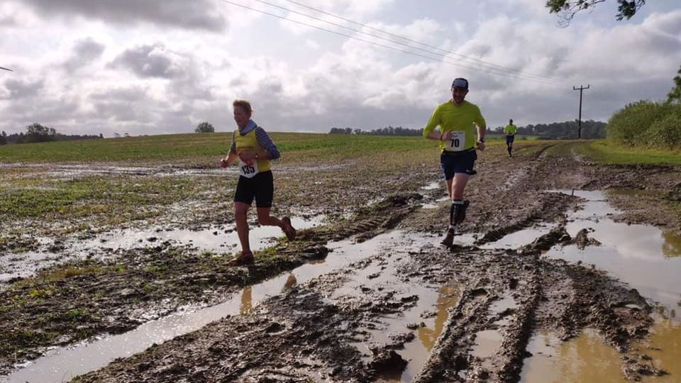 Running through muddy fields at the Clipston Trail Half Marathon