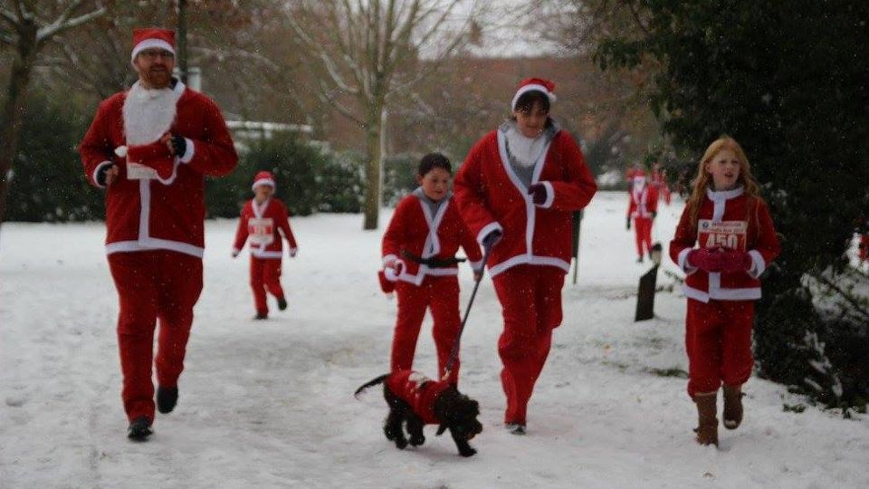 Running family plus the dog enjoys the Harborough Santa Run in wintry conditions