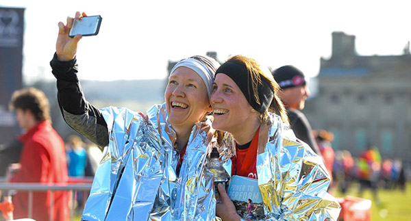 Two happy runners take selfies after Harewood House race
