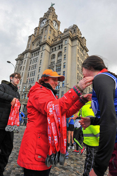 runners receiving their Liverpool Half medals